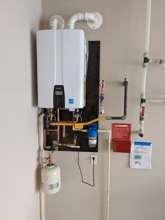 Professional plumber installing copper piping in a Brown Station home